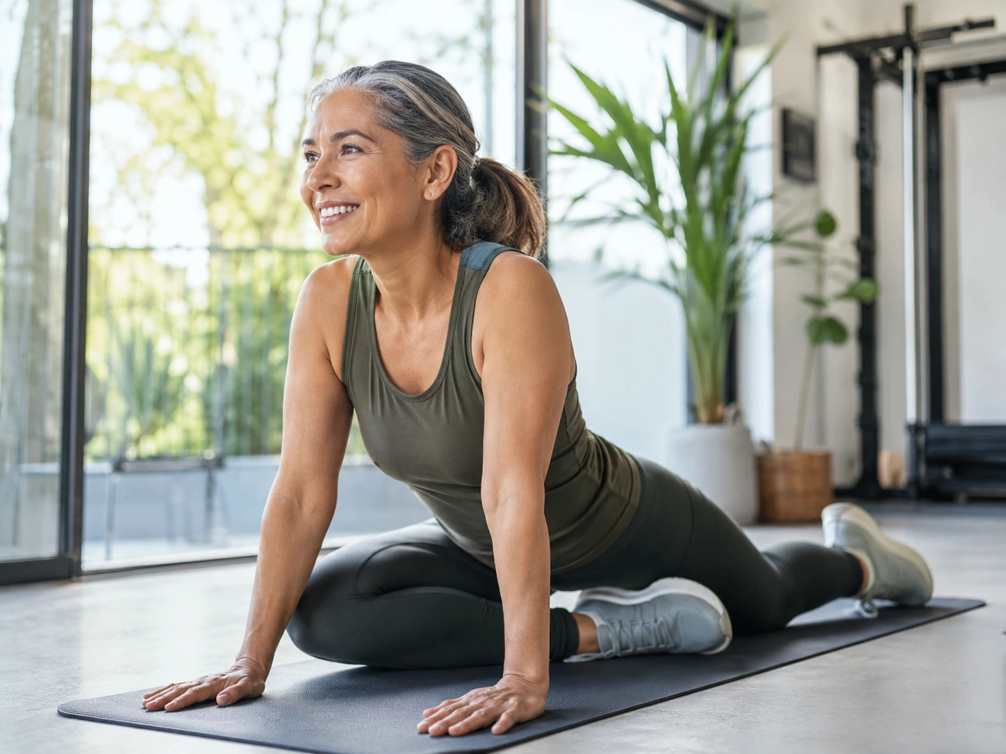 Active adult stretching in a bright home or gym setting, showing joint mobility and healthy aging.
